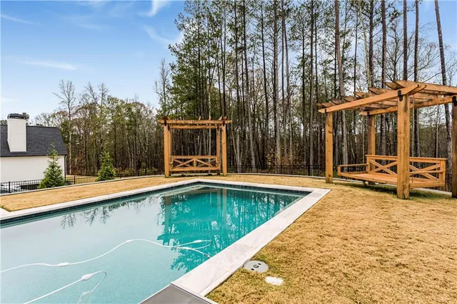 a room with gym equipment and wooden floor