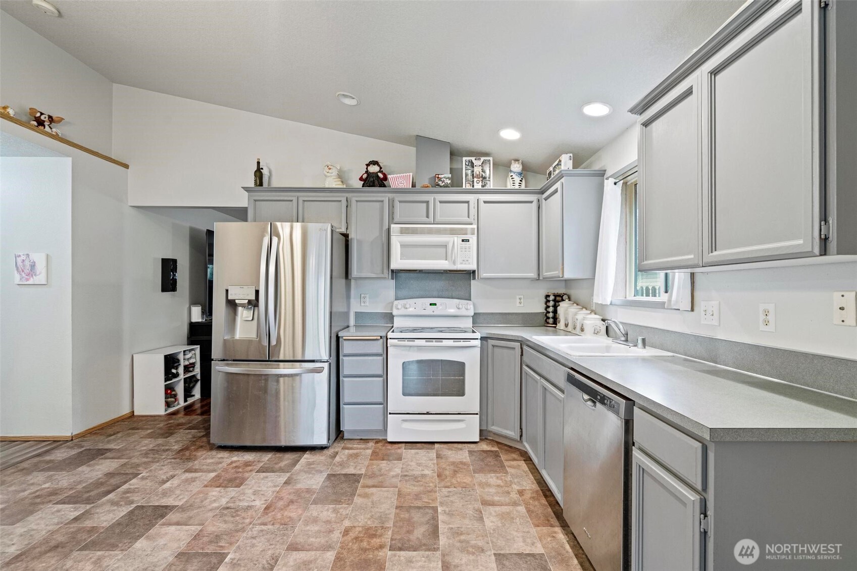 106 Rose Marie Drive Chehalis, WA 98532 - Photo 9 of 25 a kitchen with kitchen island a refrigerator sink and cabinets