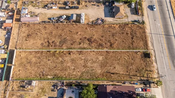an aerial view of residential houses with yard
