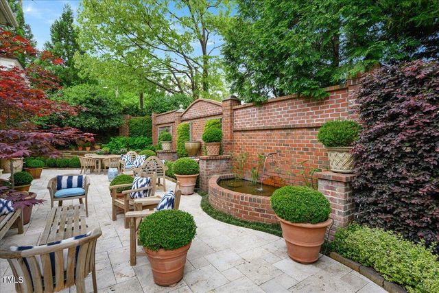 a view of a chair and table in backyard