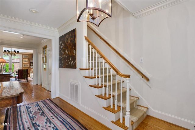 a view of entryway and hall with wooden floor