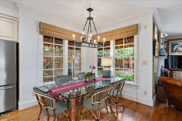 a dining room with furniture window and wooden floor