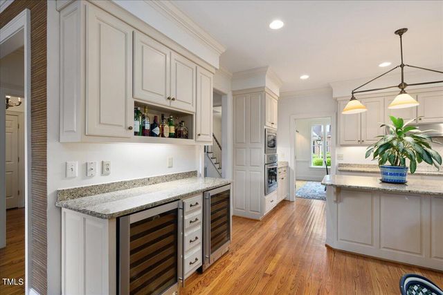 a kitchen with a stove a sink and a refrigerator
