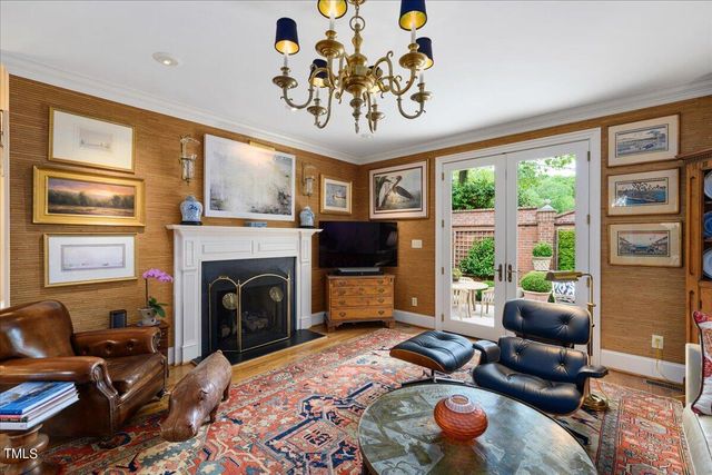 a living room with furniture a large window and a fireplace