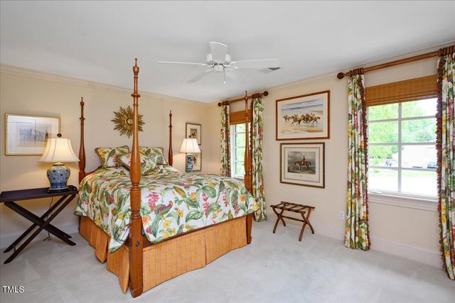 a bed room with a bed and a chandelier