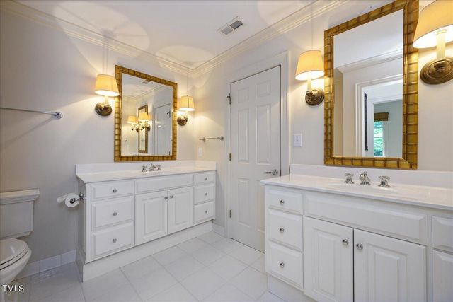 a spacious bathroom with double sink and a mirror
