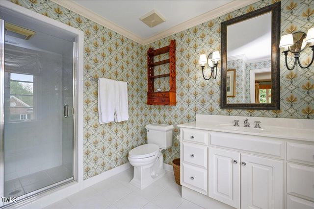 a bathroom with a double vanity sink toilet and shower