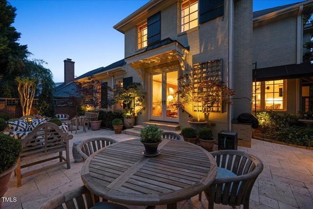 a view of a patio with couches table and chairs and potted plants