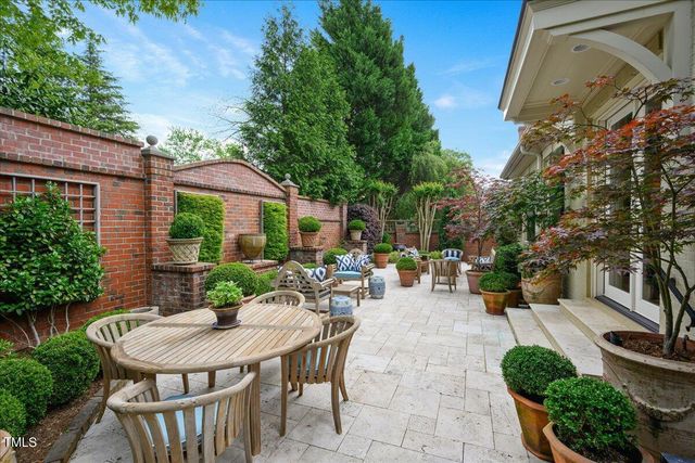 a view of a patio with a table and chairs under an umbrella
