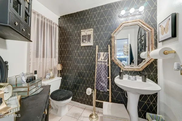 a bathroom with a sink a toilet and mirror