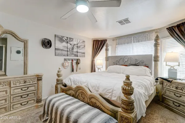 a bedroom with a bed and dresser with mirror