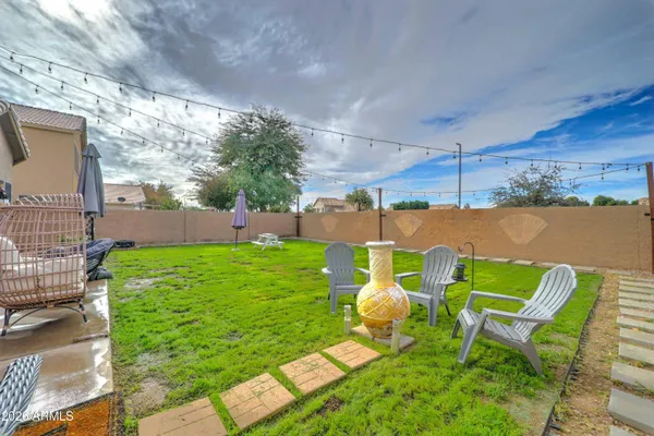 a backyard of a house with table and chairs