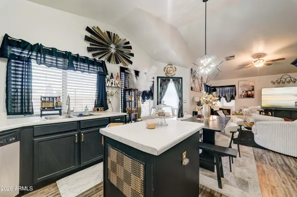 a kitchen with a sink a counter space appliances and cabinets