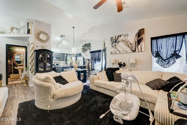 a living room with furniture and a chandelier