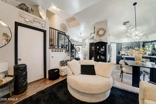 a living room with furniture a fireplace and white walls