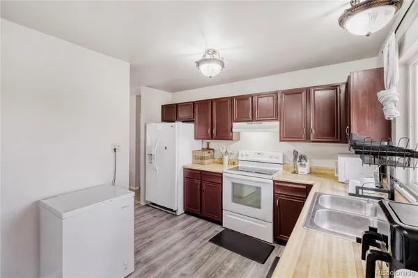 a kitchen with stainless steel appliances granite countertop a stove and a refrigerator