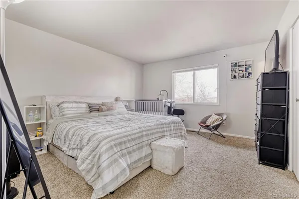 a bedroom with bed and a window