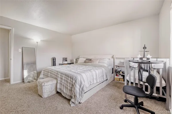a bedroom with a bed and a desk