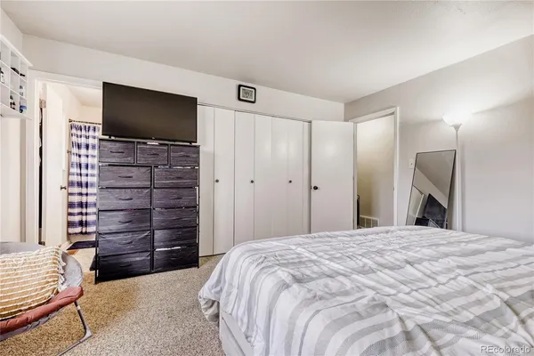 a bedroom with a bed and a flat screen tv