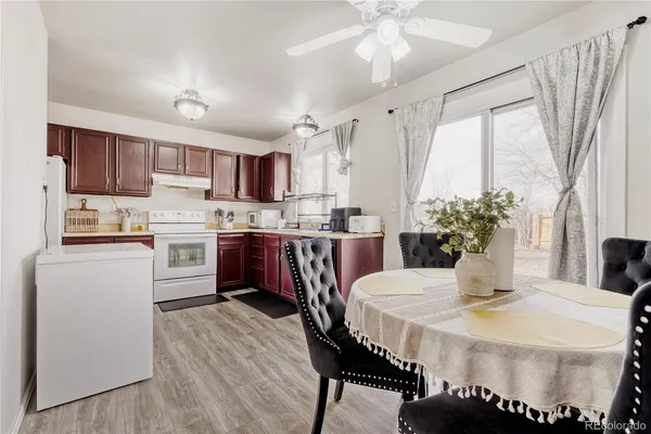 a kitchen with a table chairs refrigerator and microwave