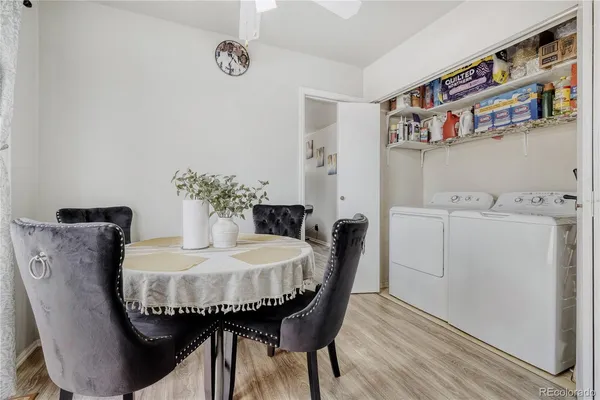a dining room with furniture and wooden floor