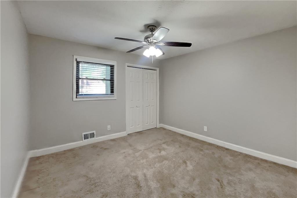 464 Ridgemont Drive Lawrenceville, GA 30046 - Photo 13 of 22 a view of an empty room with a fan