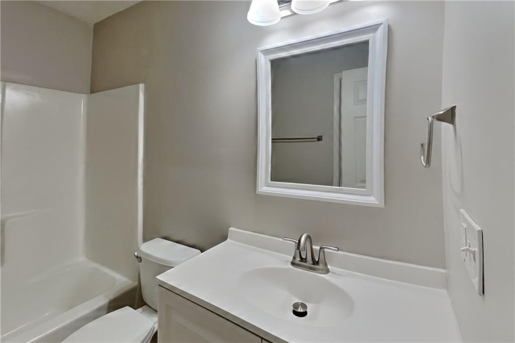 464 Ridgemont Drive Lawrenceville, GA 30046 - Photo 16 of 22 a bathroom with a sink a toilet and shower