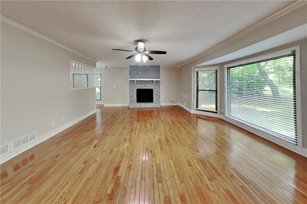 464 Ridgemont Drive Lawrenceville, GA 30046 - Photo 2 of 22 a view of an empty room with wooden floor and a window