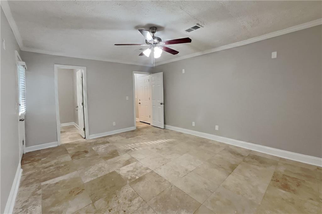 464 Ridgemont Drive Lawrenceville, GA 30046 - Photo 3 of 22 an empty room with closet and fan