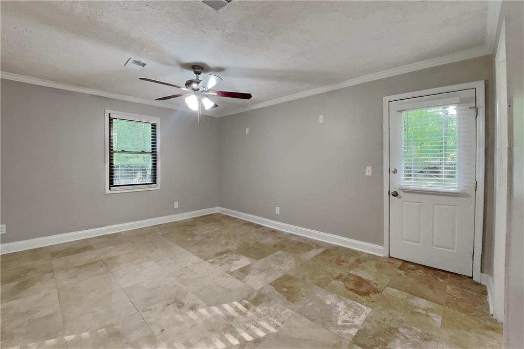 464 Ridgemont Drive Lawrenceville, GA 30046 - Photo 4 of 22 an empty room with windows and fan