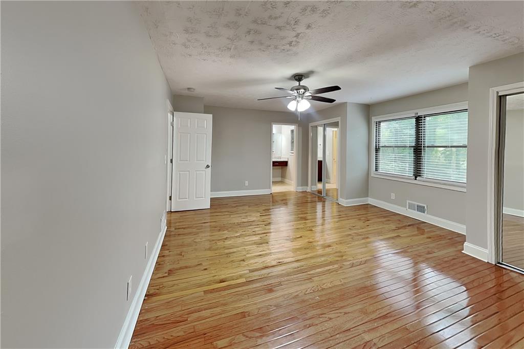 464 Ridgemont Drive Lawrenceville, GA 30046 - Photo 7 of 22 wooden floor in an empty room with a window