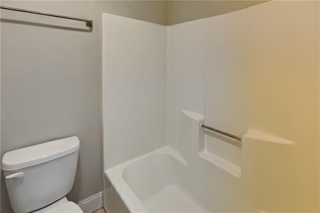 464 Ridgemont Drive Lawrenceville, GA 30046 - Photo 9 of 22 a white toilet sitting next to a shower