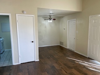 809 Plumpton Drive Austin, TX 78745 - Photo 3 of 14 Unfurnished room featuring a ceiling fan and dark wood-type flooring