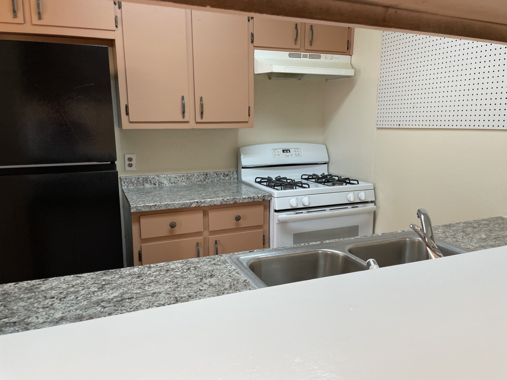809 Plumpton Drive Austin, TX 78745 - Photo 5 of 14 Kitchen featuring white gas range, freestanding refrigerator, light countertops, and cream cabinetry