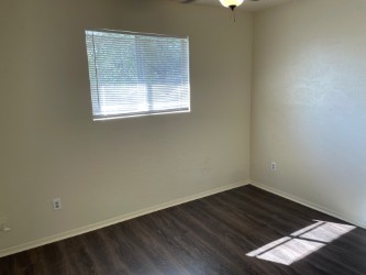 809 Plumpton Drive Austin, TX 78745 - Photo 7 of 14 Bedroom 1 -with dark wood-type flooring and a ceiling fan
