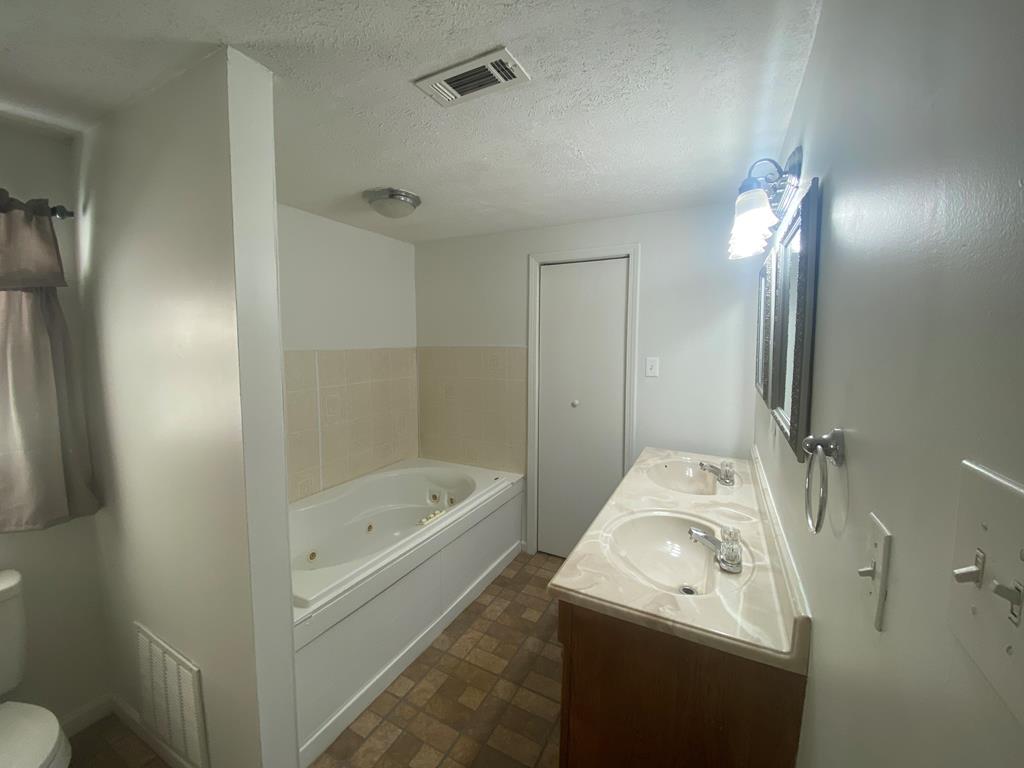 12165 Warm Springs Road Ellerslie, GA 31807 - Photo 9 of 15 a bathroom with a sink a toilet and shower
