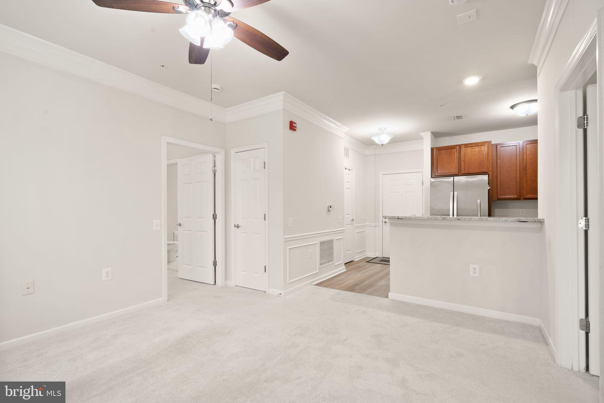 20610 Hope Spring Terrace, Unit 104 Ashburn, VA 20147 - Photo 11 of 38 Living Area and Kitchen