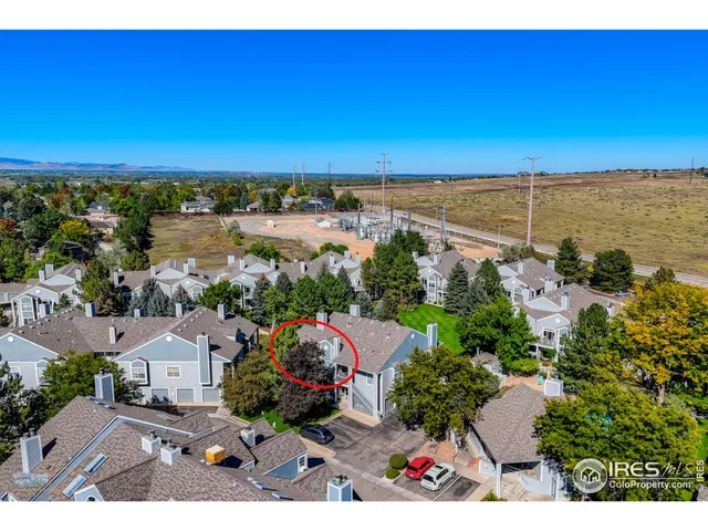 an aerial view of ocean and residential houses with outdoor space