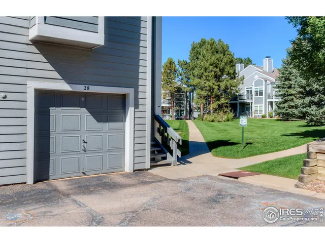 a view of a house with a yard and garage