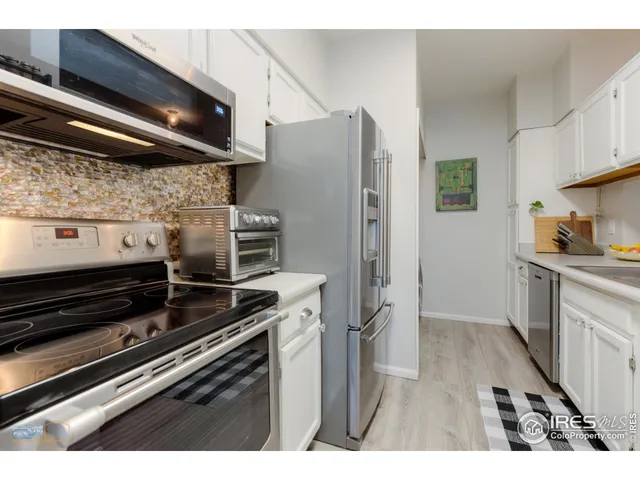 a kitchen with appliances and cabinets