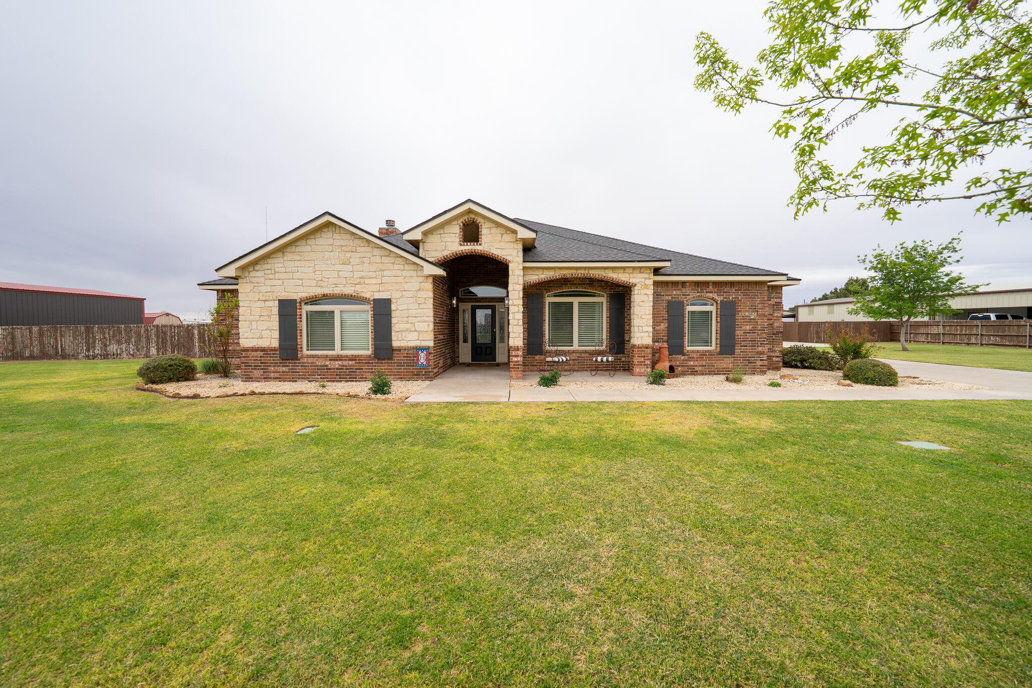 3301 County Road 7560 Lubbock, TX 79423 - Photo 4 of 40 a front view of a house with swimming pool having outdoor seating