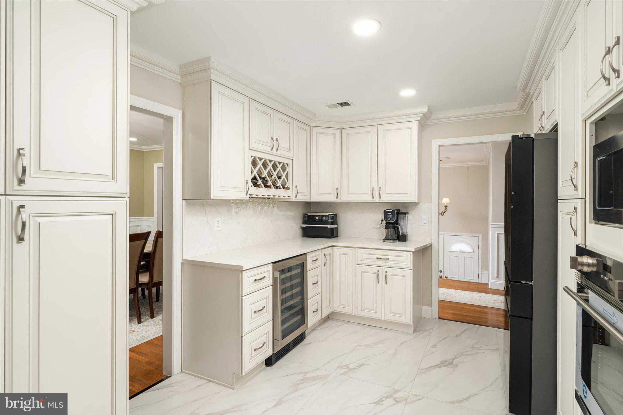 93 Tudor Drive Hamilton, NJ 08690 - Photo 11 of 67 a kitchen with stainless steel appliances a refrigerator sink and cabinets