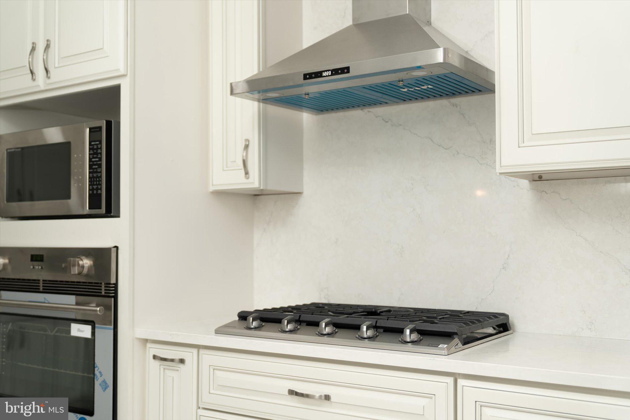 93 Tudor Drive Hamilton, NJ 08690 - Photo 15 of 67 a close view of a stove a microwave and cabinets