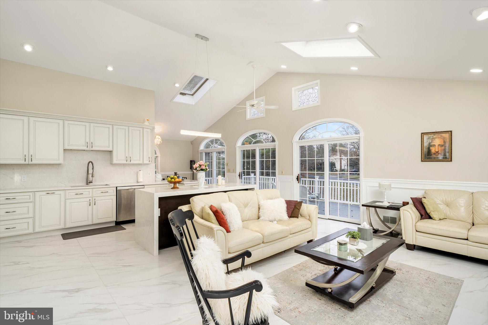 93 Tudor Drive Hamilton, NJ 08690 - Photo 22 of 67 a living room with furniture kitchen view and large windows