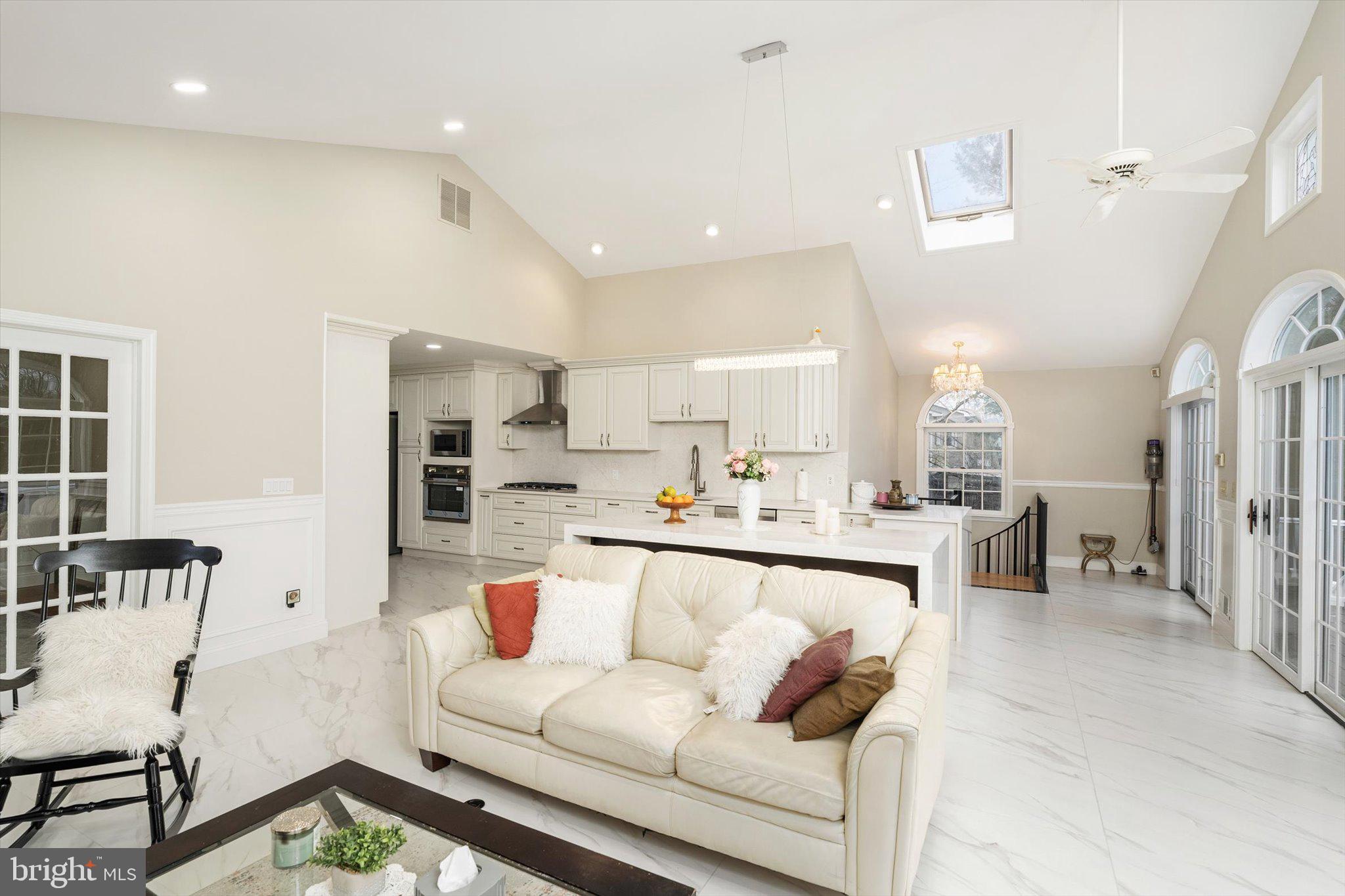 93 Tudor Drive Hamilton, NJ 08690 - Photo 23 of 67 a living room with kitchen island furniture and a view of kitchen