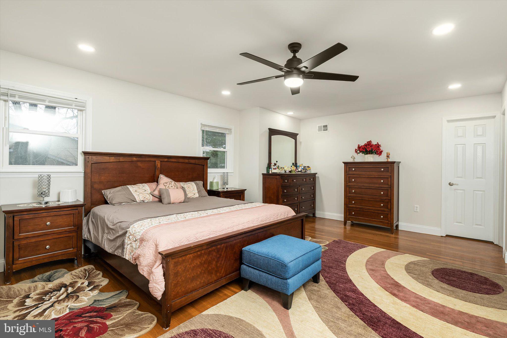 93 Tudor Drive Hamilton, NJ 08690 - Photo 30 of 67 a bedroom with a bed and a chandelier