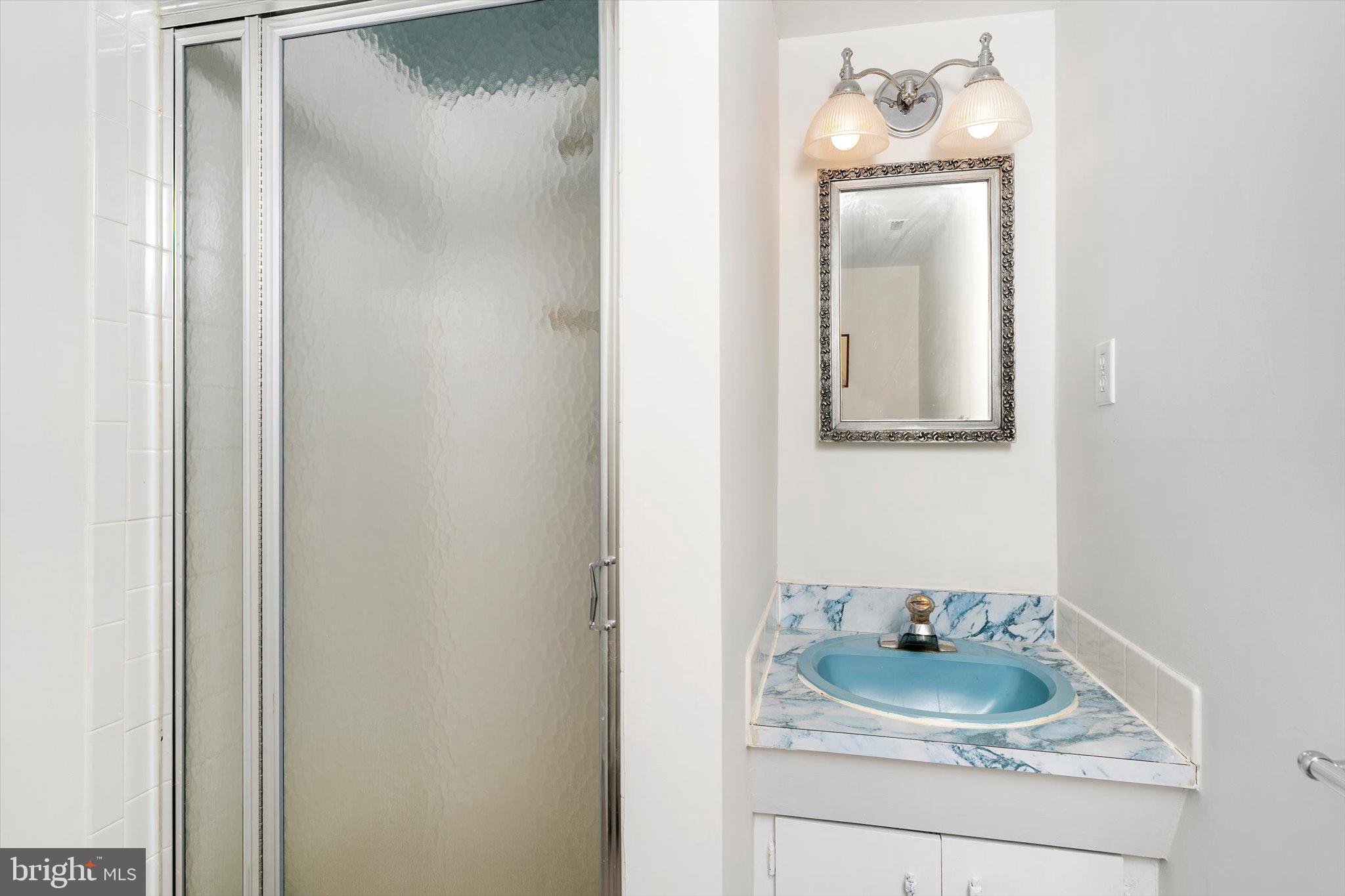 93 Tudor Drive Hamilton, NJ 08690 - Photo 54 of 67 a bathroom with a granite countertop sink and mirror