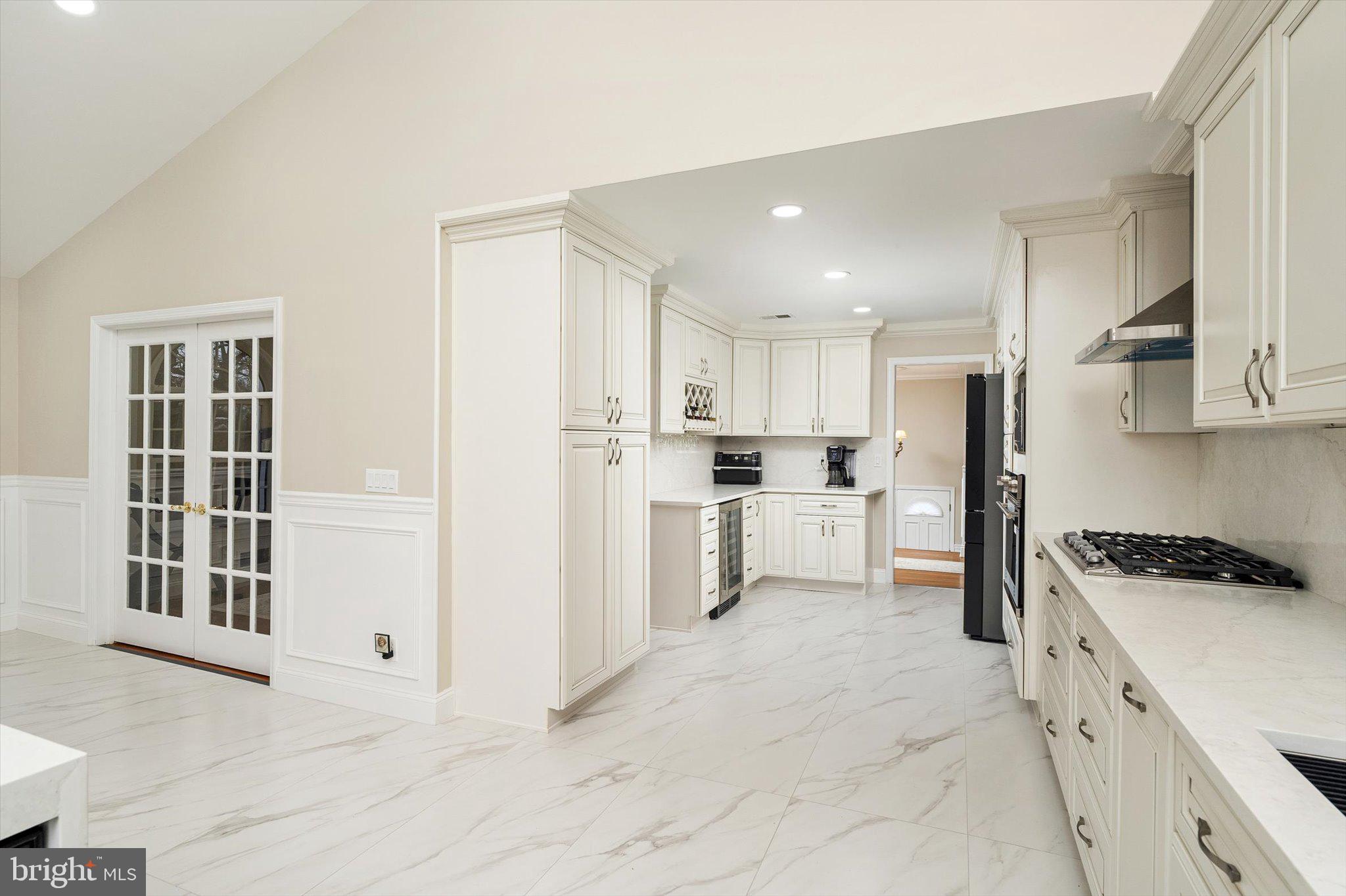 93 Tudor Drive Hamilton, NJ 08690 - Photo 10 of 67 a kitchen with white cabinets and appliances