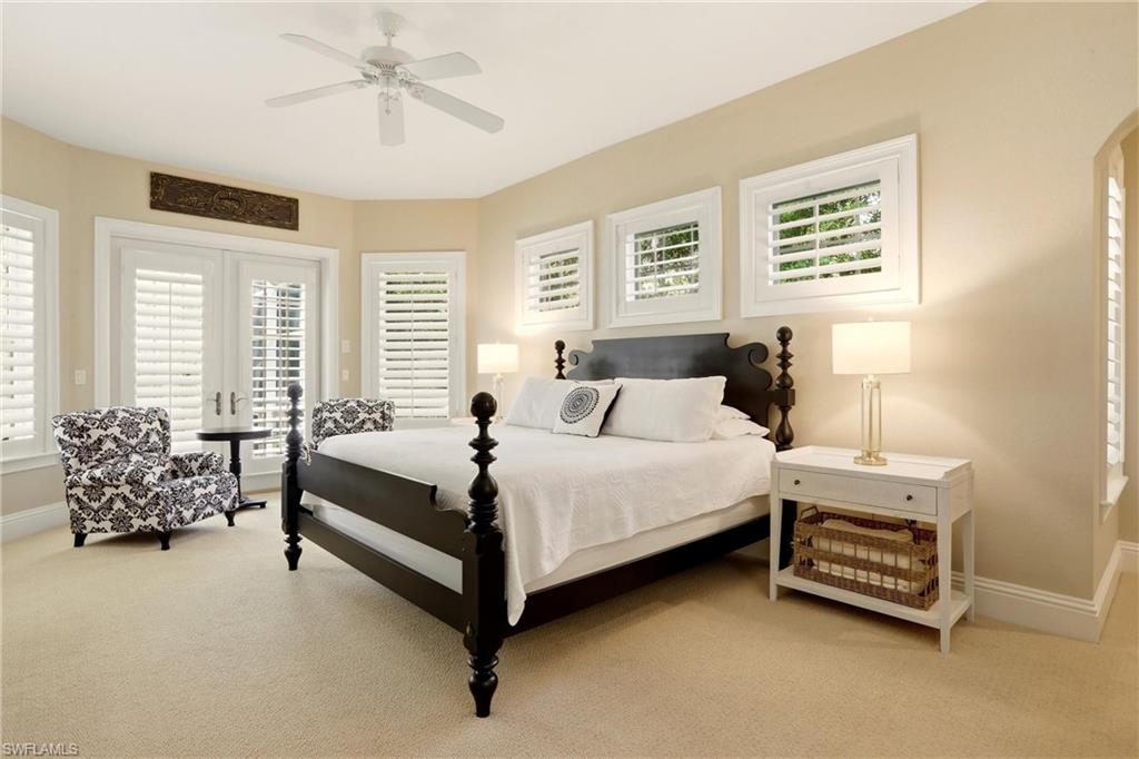 4335 7th Avenue Southwest Naples, FL 34119 - Photo 20 of 49 Bedroom featuring french doors, light carpet, ceiling fan, access to outside, and arched walkways