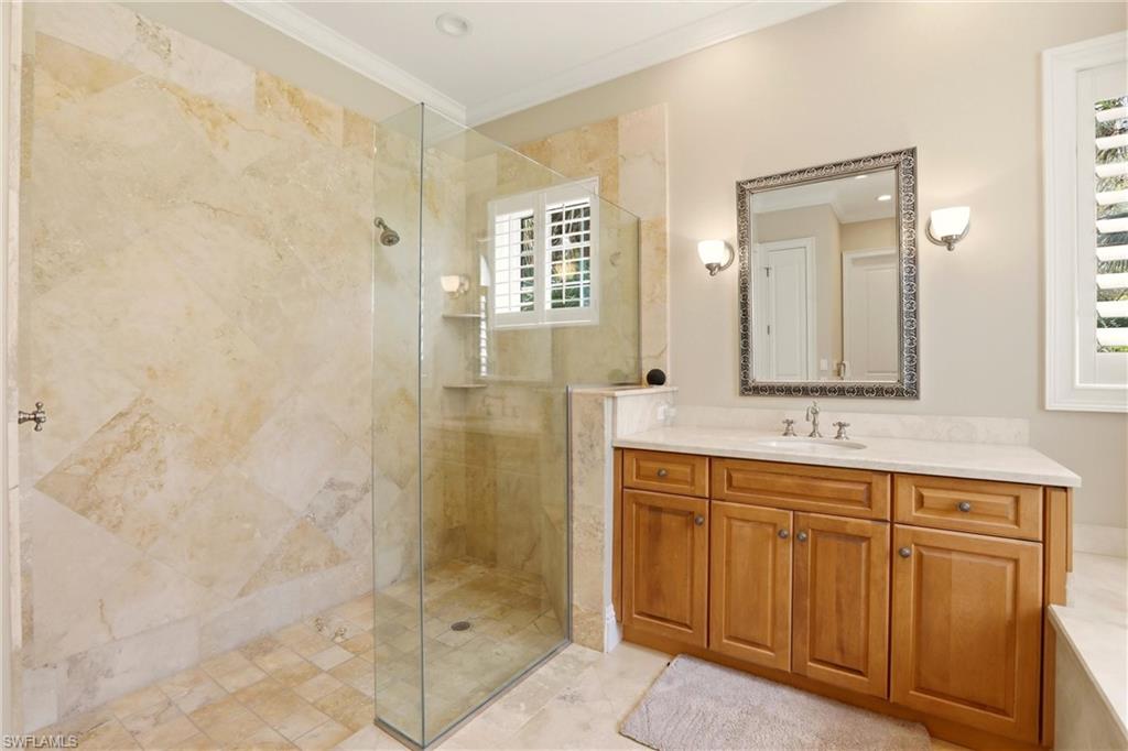 4335 7th Avenue Southwest Naples, FL 34119 - Photo 22 of 49 Bathroom with crown molding, vanity, and a stall shower